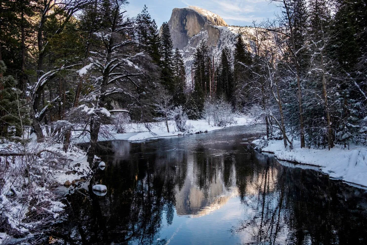 Heavy snow blankets Yosemite Valley with snow-covered trees and granite cliffs